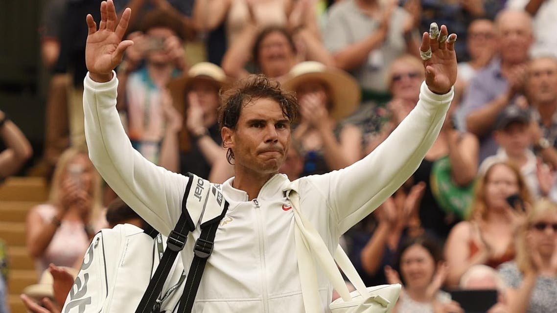 Rafael Nadal leaves the court after losing to Novak Djokovic during the continuation of their Wimbledon men’s singles semi-final match. (AFP)