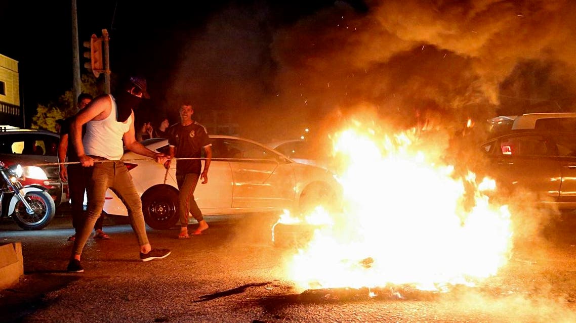 Iraqi protesters demanding services and jobs burn tires during a demonstration in Basra. (Reuters)