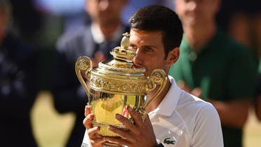 Serbia's Novak Djokovic kisses the winners the trophy after beating South Africa's Kevin Anderson 6-2, 6-2, 7-6 in their men's singles final match. (Reuters)