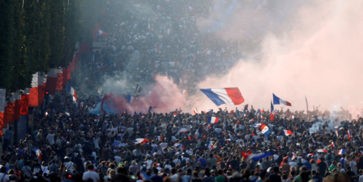 France fans react on the Champs-Elysees avenue after defeating Croatia in their World Cup final match. (Reuters)