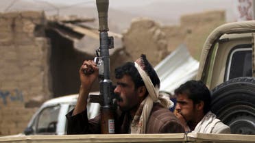 Houthi militants ride in an open vehicle while carrying weapons to secure a road in the northwestern province of Saada, June 4, 2013. (Reuters)
