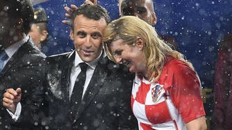 Soaked but smiling, Croatian president wins admirers at World Cup final