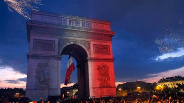 The Arc de Triomphe is illuminated with the colors of the French national flag and by fireworks set off by French soccer fans celebrating France's World Cup victory over Croatia, in Paris, France, Sunday, July 15, 2018. (AP)