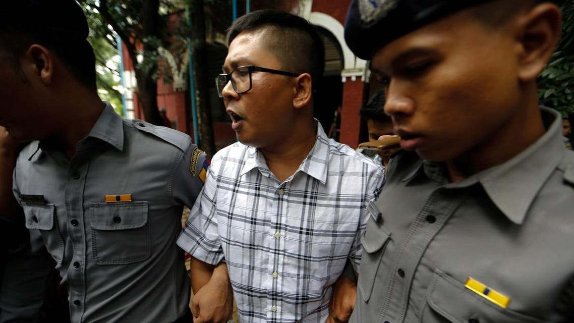 Detained Reuters journalist Wa Lone is escorted by police officers at Insein court in Yangon. (Reuters)
