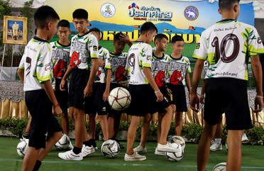 Twelve 'Wild Boars' players and their coach play soccer as they arrive for their news conference in Chiang Rai, Thailand. (Reuters)