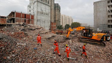 Rescue workers look for survivors among the rubbles at the site of a collapsed building in Greater Noida, on July 19, 2018. (Reuters)