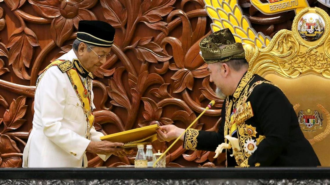Malaysian Prime Minister Mahatir Mohamad, left, passes the opening speech to King Sultan Muhammad V during the opening of the 14th parliament session at the Parliament house in Kuala Lumpur, Malaysia, Tuesday, July 17, 2018.(AP)