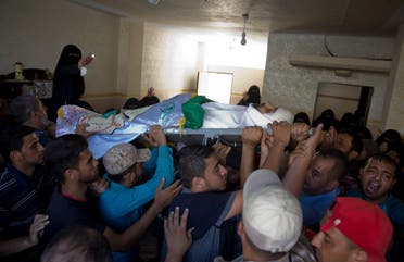 Palestinian mourners carry the body of Hamas militant Abdul Kareem Radwan, 22, out of the family home during his funeral in Town of Rafah, Southern Gaza Strip, Friday, July 20, 2018. (AP)