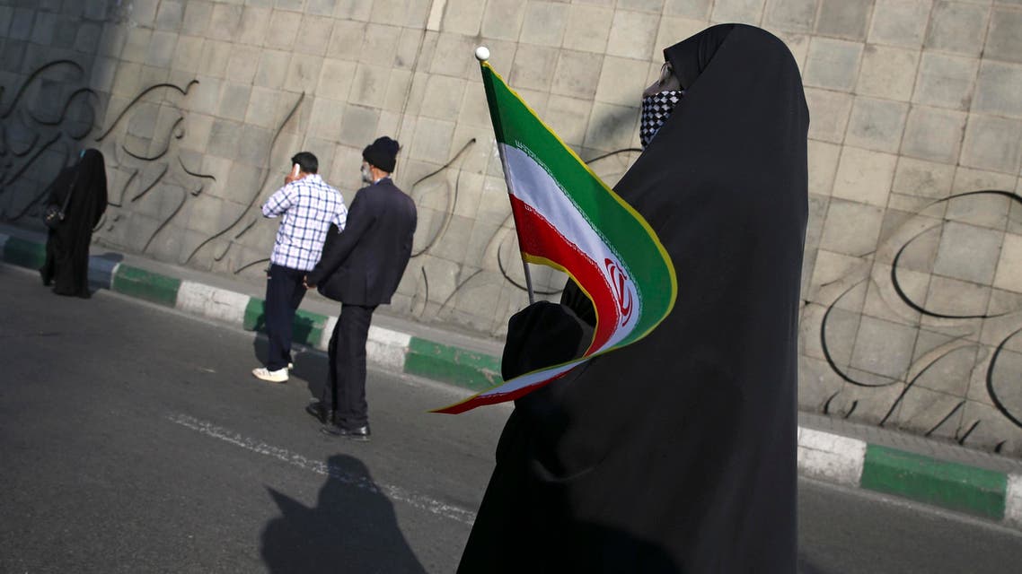 A woman holds an Iranian flag while attending a rally marking the 39th anniversary of Iran’s 1979 Islamic Revolution, in Tehran on Feb. 11, 2018. (AP)
