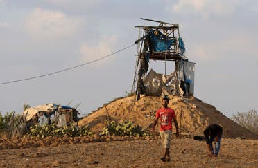 Palestinians inspect a military observation post that was hit by an Israeli tank shell east of Khan Younis, southern Gaza Strip, Friday, July 20, 2018. (AP)