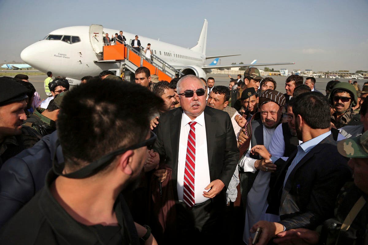 Afghan first vice president, Gen. Abdul Rashid Dostum (center), and members of his entourage arrive at Kabul International Airport, Afghanistan, on July 22, 2018. (AP)