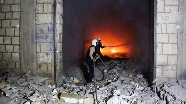 Syrian civil defence volunteers, known as the White Helmets, try to extinguish fire reportedly caused by air strikes in Idlib. (File photo: AFP)