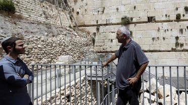 People stand near the part f the Western Wall where one of the stones dislodged and crashed into the prayer area in Jerusalem. (AP)