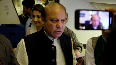 Ousted Pakistani Prime Minister Nawaz Sharif gestures as he boards a Lahore-bound flight due for departure, at Abu Dhabi International Airport. (Reuters)