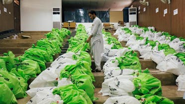 A worker arranges sacks of election materials for distribution among electoral workers, at a distribution point, ahead of general election in Peshawar. (Reuters)