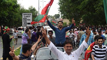Supporters of Imran Khan’s Pakistan Tehreek-e-Insaf take to the street to celebrate after polls closed in Lahore on July 25, 2018. (AFP)