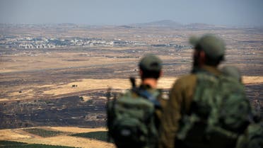 Israeli soldiers look at the Syrian side of the Israel-Syria border on the Israeli-occupied Golan Heights, Israel July 7, 2018. REUTERS/Ronen Zvulun