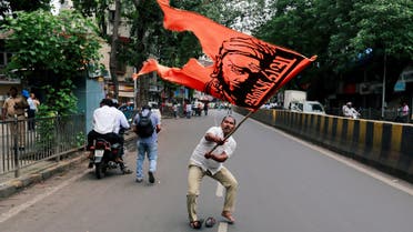 A man waves a flag as he blocks a road during a protest in Mumbai on July 25, 2018. (Reuters)