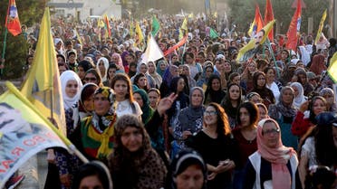 Syrian-Kurdish demonstrators wave Kurdish flag during a protest in Qamishli on June 23, 2018. (AFP)