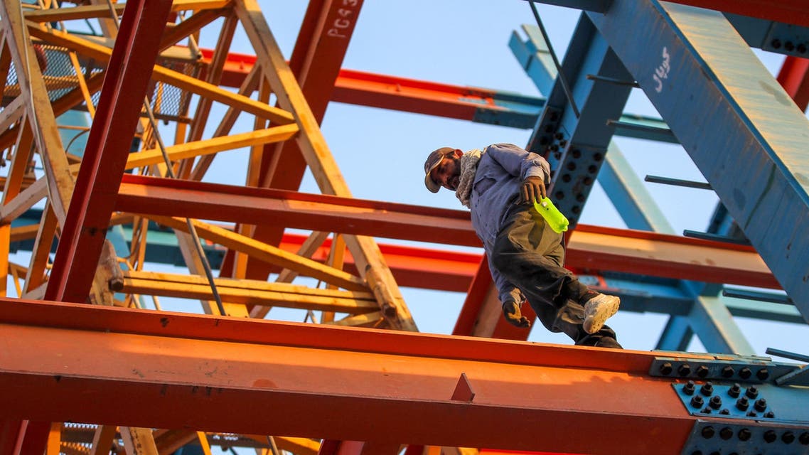An Iranian construction worker walks on a steel I-beam at a site in Baghdad on June 28, 2018. (File photo: AFP)