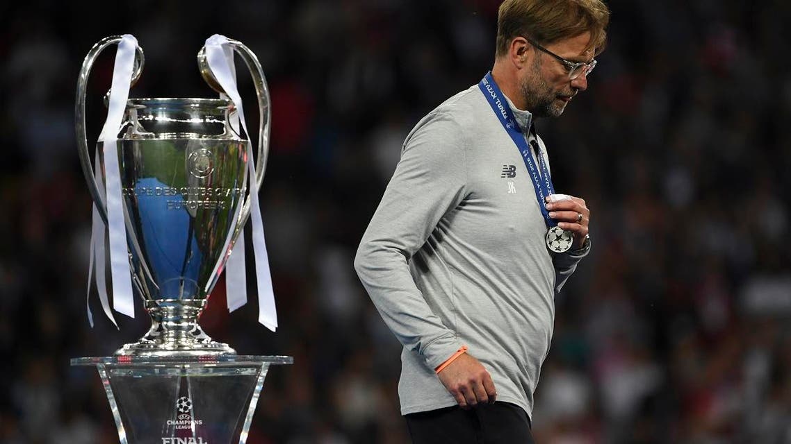 Liverpool’s Jurgen Klopp walks past the trophy as he collects his loser’s medal after the UEFA Champions League final football match between Liverpool and Real Madrid in Kiev, Ukraine on May 26, 2018. (AFP)
