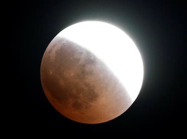 A “Super Blue Blood Moon” rises during the lunar eclipse over Cairo, Egypt, on July 27, 2018. (Reuters)