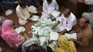 Pakistani election staff count the votes following polls closed at a polling station for the parliamentary elections in Karachi, Pakistan, Wednesday, July 25, 2018. (AP)