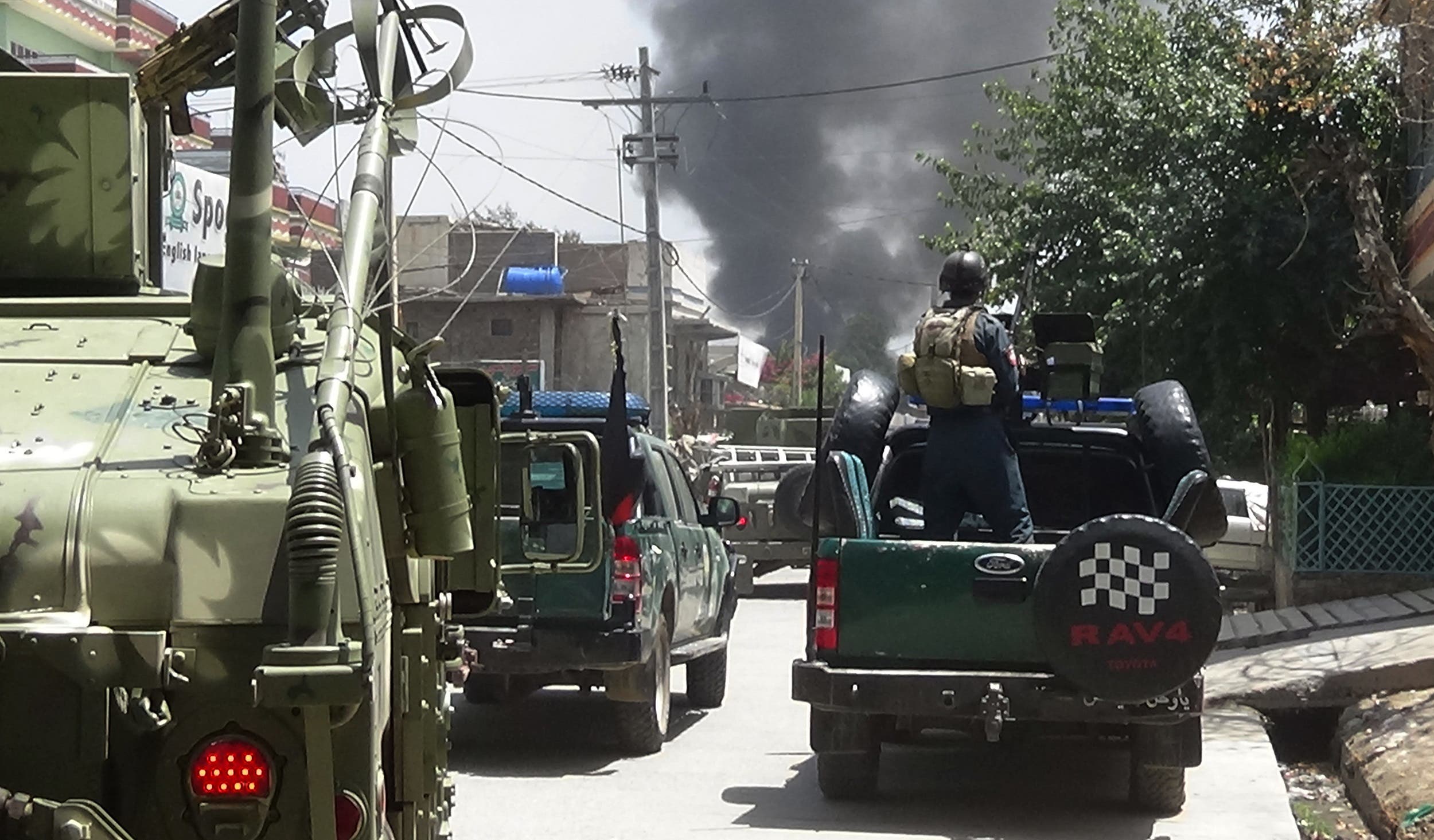 Afghan Security personnel arrive as smoke rises from the site of an attack in Jalalabad on July 28, 2018. (AFP)