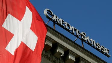 Switzerland’s national flag flies next to the logo of Swiss bank Credit Suisse in Luzern, Switzerland, on October 19, 2017. (Reuters)