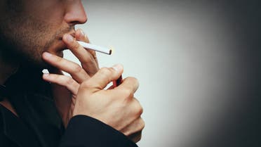 Smoking a cigarette. - Stock image