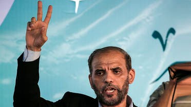 Member of the political bureau of Hamas Husam Badran flashes the V for victory sign near the Israel-Gaza border, east of Gaza city on August 3, 2018. (AFP)