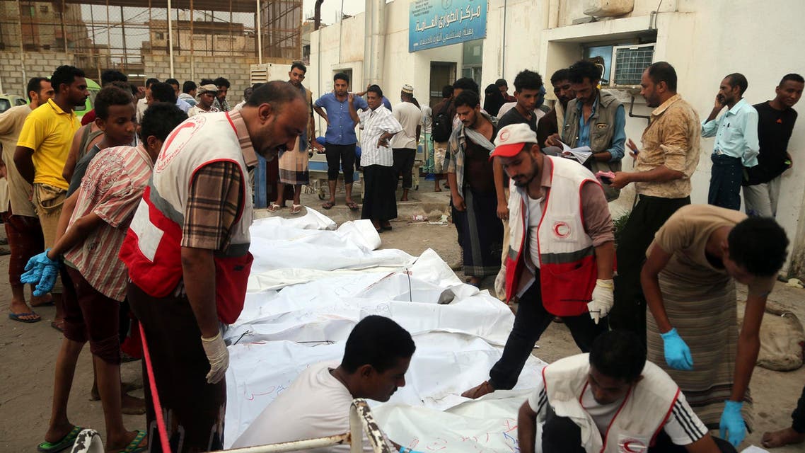 Relatives of victims gather around their bodies outside a hospital morgue after an air strike in the Red Sea town of Hodeida on August 2, 2018. (AFP)
