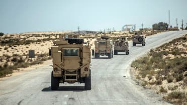 A picture taken on July 26, 2018 shows Egyptian policemen driving on a road leading to the North Sinai provincial capital of El-Arish. (AFP)