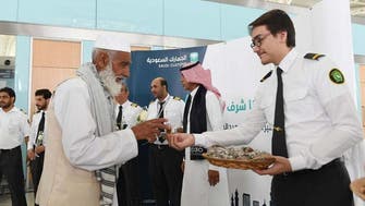Pilgrims arriving at Madinah airport welcomed with flowers and sweet treats 