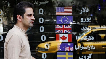 An Iranian walks in front of a currency exchange shop in Tehran on August 8, 2018. (AFP)