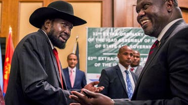 In this file photo dated Thursday, June 21, 2018, South Sudan's President Salva Kiir, left, and opposition leader Riek Machar, right, shake hands during peace talks in Addis Ababa, Ethiopia. (AP)
