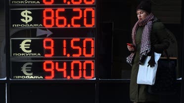 A woman walks past a board listing foreign currency rates against the Russian ruble in Moscow, on January 21, 2016. (File photo: AFP)