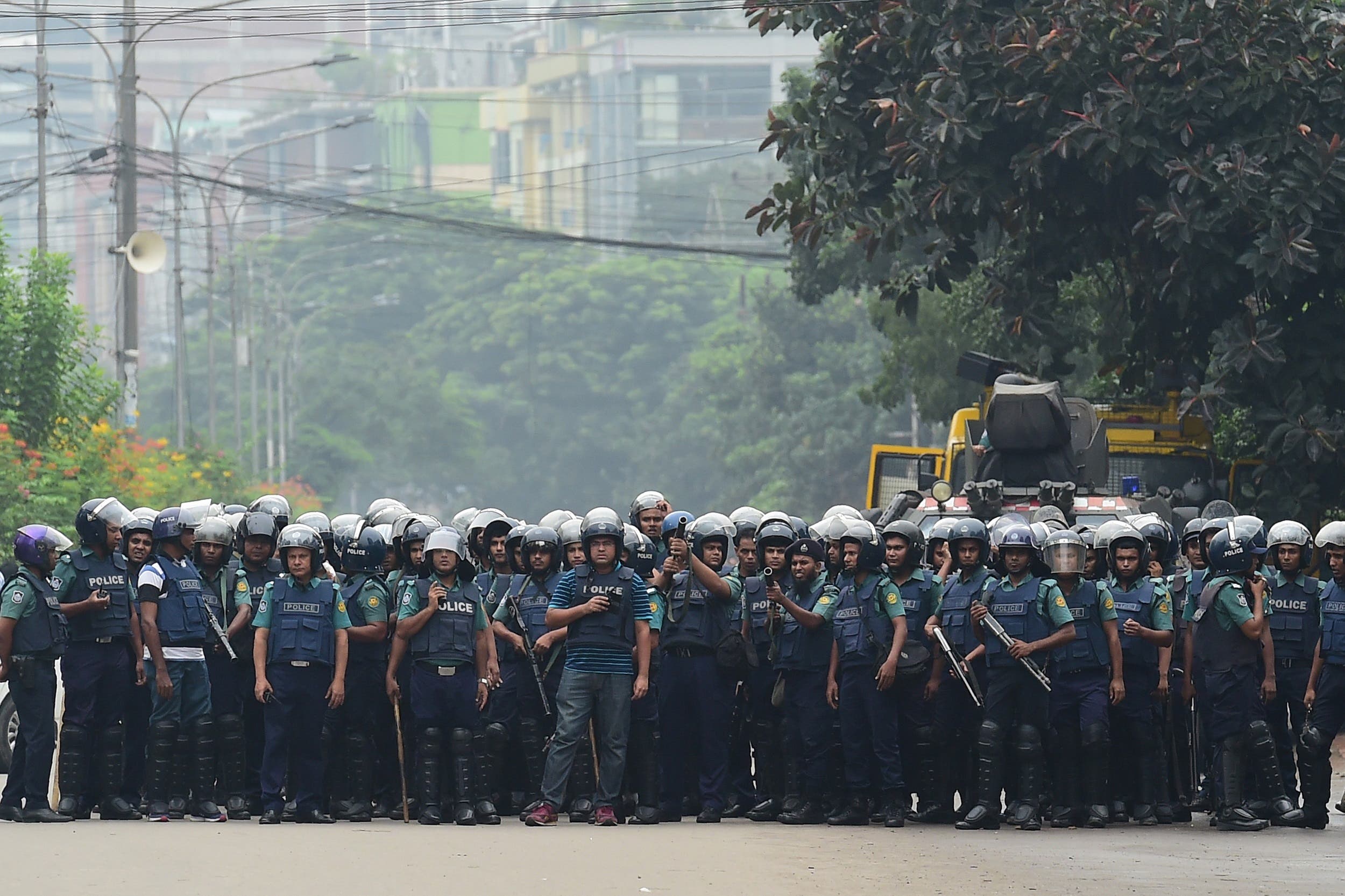 Bangladeshi police stand guard during a student protest in Dhaka on August 5, 2018. (AFP)