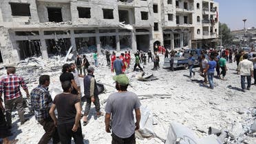 Syrians gather at a site of car bomb in the northwestern Syrian city of Idlib on August 2, 2018. (AFP)