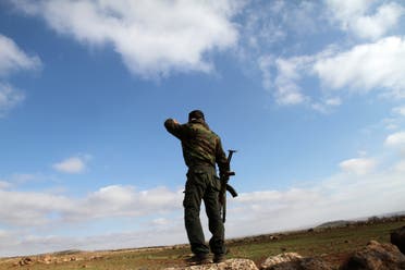 A Syrian soldier looks over at the town of Daraa from his position in the southern city of Sweida. (AFP)