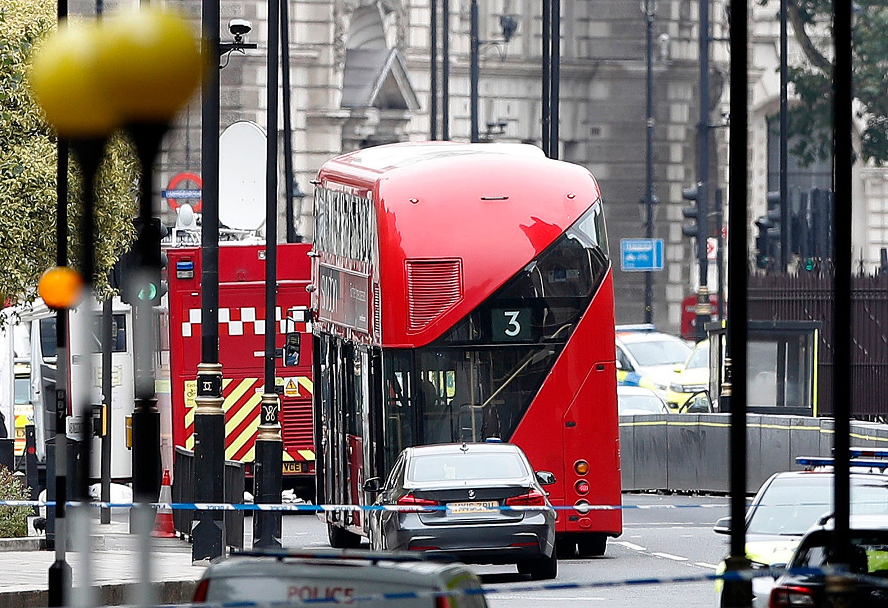 A car that crashed into security barriers outside the Houses of Parliament stands to the right of a bus in London, Tuesday, Aug. 14, 2018. (AP)