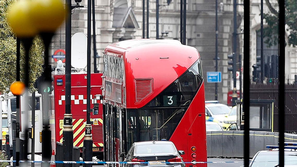 A car that crashed into security barriers outside the Houses of Parliament stands to the right of a bus in London, Tuesday, Aug. 14, 2018. (AP)