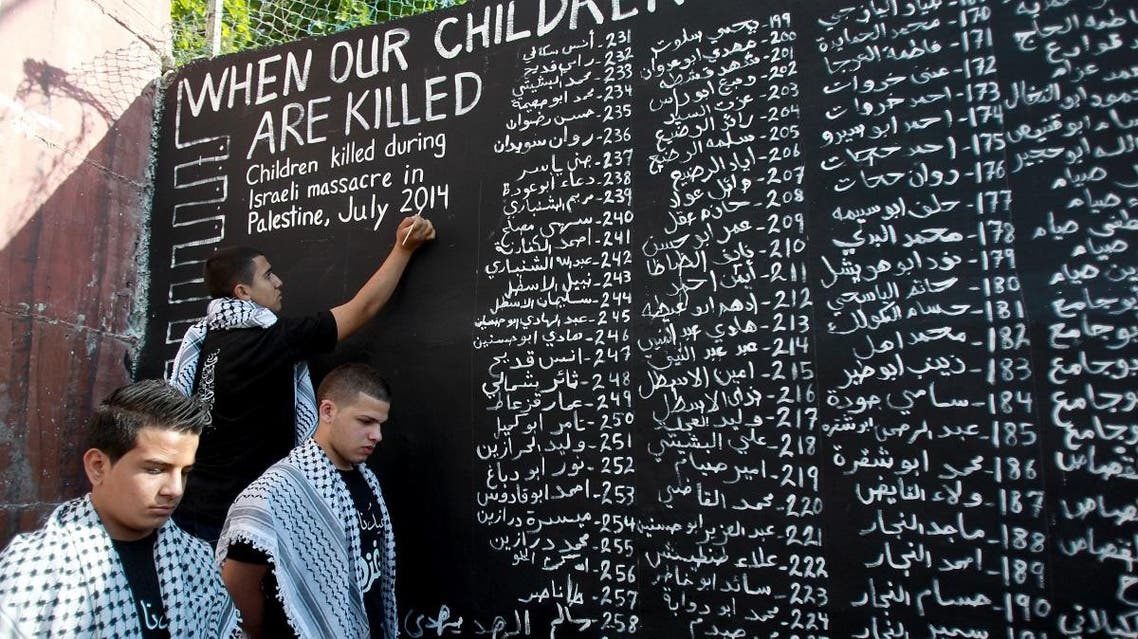 Names of Palestinians killed in Gaza in 2014 (AFP)