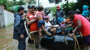 Fire and Rescue personnel evacuate local residents in an inflatable boat from a flooded area at Muppathadam near Eloor in Kochi’s Ernakulam district, in Kerala on August 15, 2018. (AFP)