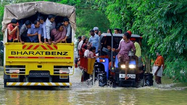 Flood affected people are rescued in a tractor, right as volunteers go for rescue work in a truck, left, at Kainakary in Alappuzha district, Kerala state, India, Friday, Aug. 17, 2018. (AP)