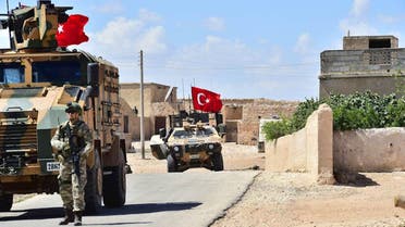 A handout picture realeased by the Turkish Armed Forces shows Turkish soldiers accompanied by armoured vehicles patrolling between the city of Manbij in northern Syria and an area it controls after a 2016-2017 military incursion on June 18, 2018. Turkey said it had started military patrols in an area around the Kurdish-held city of Manbij, in line with an agreement with the United States to scale down tensions in the region.