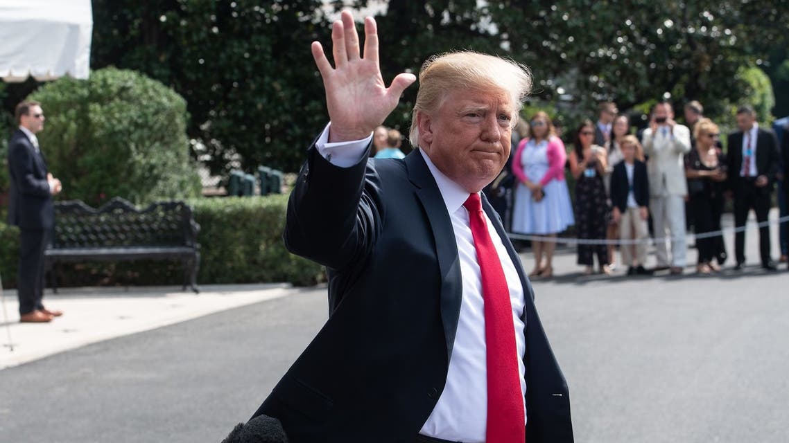 US President Donald Trump waves to the press before boarding Marine One at the White House in Washington, DC, on August 17, 2018 as he departs for a fundraiser in West Hampton Beach, New York.