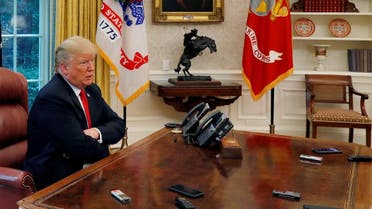 Trump answers question as eight devices record him during interview with Reuters in Oval Office of White House in Washington. (Reuters)