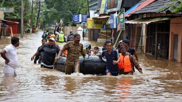Rescuers evacuate people from a flooded area to a safer place in Aluva. (Reuters)