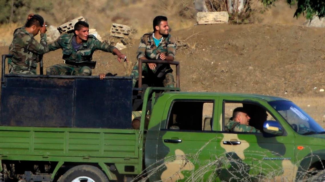 Syrian soldiers arrive to Syria's Quneitra border crossing between Syria and the Israeli-controlled Golan Heights. (AP)